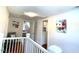 Upper level hallway with an interior view of another room and a white railing at 11609 Us 401, Fuquay Varina, NC 27526