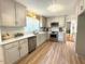 Bright kitchen with stainless steel appliances, white cabinets and light wood floors at 11609 Us 401, Fuquay Varina, NC 27526