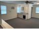Bright, spacious living room featuring a wet bar area, neutral carpet, and ample natural light from three windows at 11609 Us 401, Fuquay Varina, NC 27526