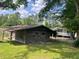 Rustic outbuilding featuring sliding doors, wagon wheel decor, and weathered wood, adding charm to the property at 11609 Us 401, Fuquay Varina, NC 27526