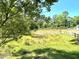 This view shows a serene pond surrounded by lush greenery and fencing at 11609 Us 401, Fuquay Varina, NC 27526