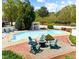 This in-ground pool features chairs, a fire pit, and nearby landscaping at 11609 Us 401, Fuquay Varina, NC 27526