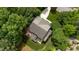 Drone image of home featuring a deck, outdoor seating, well maintained landscaping and a long driveway at 118 Killingsworth Dr, Cary, NC 27518