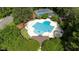 Aerial view of community pool, tennis courts, and clubhouse amid lush greenery at 118 Killingsworth Dr, Cary, NC 27518