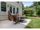 A stone patio with a table and chairs is accessible from the house, offering seamless indoor-outdoor living at 118 Killingsworth Dr, Cary, NC 27518