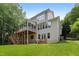 Well-manicured backyard with lush lawn, open patio area, screened-in porch, and multi-level wooden deck at 118 Killingsworth Dr, Cary, NC 27518