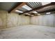Spacious unfinished basement with concrete floor and walls, exposed beams, and natural light at 118 Killingsworth Dr, Cary, NC 27518