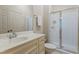 Clean bathroom featuring glass enclosed shower, vanity with a sink, and neutral tile flooring at 118 Killingsworth Dr, Cary, NC 27518