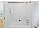White tiled tub/shower combo with built in wall niche for soaps and washcloths at 118 Killingsworth Dr, Cary, NC 27518