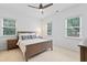 Inviting bedroom featuring neutral tones, a ceiling fan, and large windows for natural lighting at 118 Killingsworth Dr, Cary, NC 27518