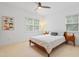 Comfortable bedroom featuring a ceiling fan, a dinosaur poster and a view to the backyard at 118 Killingsworth Dr, Cary, NC 27518