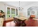 Elegant dining room featuring a large window, modern chandelier, and stylish decor at 118 Killingsworth Dr, Cary, NC 27518