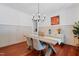 Stylish dining room with modern table, elegant chandelier, and decorative wall paneling at 118 Killingsworth Dr, Cary, NC 27518