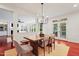 Open dining area features hardwood floors, stylish lighting, a wooden table and view to the living room at 118 Killingsworth Dr, Cary, NC 27518