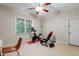 Home gym with ceiling fan, carpet, workout bench, exercise bike, and large window at 118 Killingsworth Dr, Cary, NC 27518