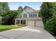 Charming two-story home featuring a welcoming front porch, a two-car garage, and lush landscaping at 118 Killingsworth Dr, Cary, NC 27518