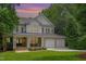 Stunning two-story home featuring a welcoming front porch, two-car garage, and manicured landscaping at 118 Killingsworth Dr, Cary, NC 27518