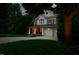 Inviting two-story home featuring a welcoming front porch, a two-car garage, and manicured landscaping at 118 Killingsworth Dr, Cary, NC 27518
