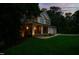 Inviting two-story home featuring a welcoming front porch, a two-car garage, and manicured landscaping at 118 Killingsworth Dr, Cary, NC 27518