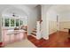 Open foyer with hardwood floors, arched doorways, and a view into the living room at 118 Killingsworth Dr, Cary, NC 27518