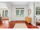 Bright foyer with hardwood floors, white trim, and double doors leading to the outside at 118 Killingsworth Dr, Cary, NC 27518