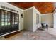 Inviting front porch with stone flooring, cozy seating, and a stylish double door entrance at 118 Killingsworth Dr, Cary, NC 27518