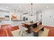 Open kitchen and dining area features hardwood floors, stainless appliances, and stylish lighting at 118 Killingsworth Dr, Cary, NC 27518