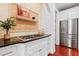 Kitchen with tile backsplash, stainless fridge and stove and white cabinets at 118 Killingsworth Dr, Cary, NC 27518