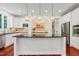 Kitchen features granite countertops, stainless appliances, white cabinets, and stylish pendant lighting at 118 Killingsworth Dr, Cary, NC 27518