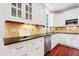 Kitchen with granite countertops, stainless appliances, white cabinets, and tile backsplash at 118 Killingsworth Dr, Cary, NC 27518