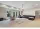 Bright living space with backyard view through expansive windows, neutral decor, and comfortable furniture at 118 Killingsworth Dr, Cary, NC 27518