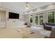 Bright and open living room featuring a ceiling fan, patio doors to the backyard and built-ins at 118 Killingsworth Dr, Cary, NC 27518