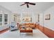 Open living room with hardwood floors, a neutral rug, a leather sofa and an open view to the kitchen at 118 Killingsworth Dr, Cary, NC 27518