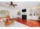 Living room features a fireplace with built-in shelving, hardwood floors and view to the foyer at 118 Killingsworth Dr, Cary, NC 27518