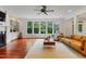 Bright living room with hardwood floors, large windows, and a cozy fireplace at 118 Killingsworth Dr, Cary, NC 27518