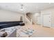 Spacious living area featuring neutral walls, cozy carpeting, modern furnishings, and a staircase at 118 Killingsworth Dr, Cary, NC 27518