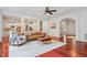 Open living room with hardwood floors, a neutral rug, a leather sofa and view to the staircase at 118 Killingsworth Dr, Cary, NC 27518