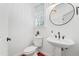 Stylish powder room with a pedestal sink and wood floors at 118 Killingsworth Dr, Cary, NC 27518