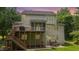 Back exterior featuring a wooden deck with grill, a screened-in porch, and a brick patio at 118 Killingsworth Dr, Cary, NC 27518
