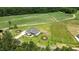 Beautiful aerial view of a home with a large lawn and a unique farmland backdrop at 120 Firefly Ln, Louisburg, NC 27549