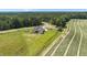 Scenic aerial shot of a house with a well-manicured lawn, flanked by farmland at 120 Firefly Ln, Louisburg, NC 27549
