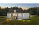 Exterior of the home at dusk with the back porch and backyard at 120 Firefly Ln, Louisburg, NC 27549