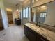 Elegant bathroom with dual vanities, marble countertops, and a spacious walk-in shower and closet at 120 Firefly Ln, Louisburg, NC 27549