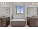 Luxurious bathroom with double vanities, soaking tub, and modern fixtures at 120 Firefly Ln, Louisburg, NC 27549
