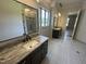 Elegant bathroom with dual vanities, marble countertops, and a spacious walk-in shower and closet at 120 Firefly Ln, Louisburg, NC 27549