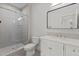 Modern bathroom featuring tiled shower, glass door, and vanity with marble countertop at 120 Firefly Ln, Louisburg, NC 27549