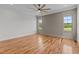 Bedroom features hardwood floors, decorative accent wall, and windows with views of the landscape at 120 Firefly Ln, Louisburg, NC 27549
