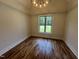 Bright bedroom with hardwood floors, recessed lighting, and a large window with green view at 120 Firefly Ln, Louisburg, NC 27549