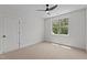 Bedroom with neutral carpet, white walls, bright window, and ceiling fan at 120 Firefly Ln, Louisburg, NC 27549