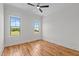 An empty bedroom features hardwood floors, white walls, and a ceiling fan at 120 Firefly Ln, Louisburg, NC 27549